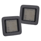 A pair of F150 License plate lights of black housing with smoke lens. Two square gray filters with textured surface on a white background