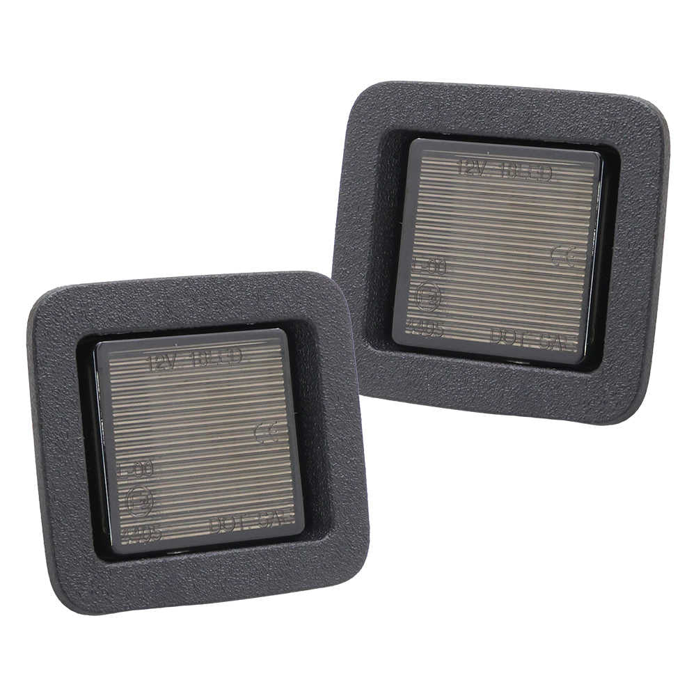 A pair of F150 License plate lights of black housing with smoke lens. Two square gray filters with textured surface on a white background