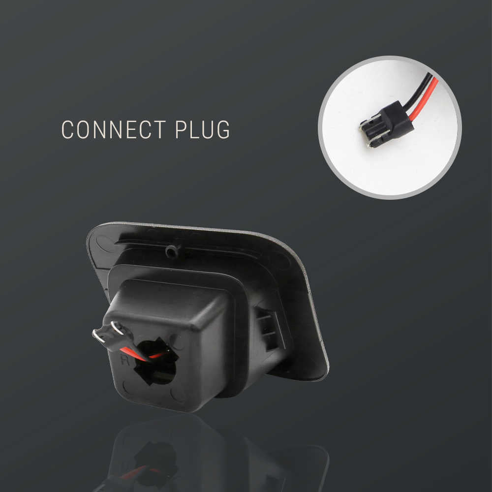 Black plastic vehicle rear-view camera connector module with a circular inset showing the plug details, on a dark gray background with the text 'CONNECT PLUG'.
