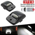 Two black Toyota Tacoma and Tundra truck bed light modules shown on a white background, with text indicating model years 2005-2015 and 2000-2013, plus inset photos demonstrating the lights in use.