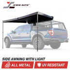 JCwin Auto side awning with light mounted over a blue pickup truck, shown on a white background with product feature text and badges.