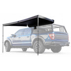 Black truck bed cover on a blue pickup truck with a white background