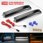 A pair of smoked marker light assemblies for a Ford F150 2009-2014 Raptor, shown with red wiring harnesses, blue connector clips, and a bottom strip showing illuminated amber and white light functions. The brand 'Sequential' is visible on the right.