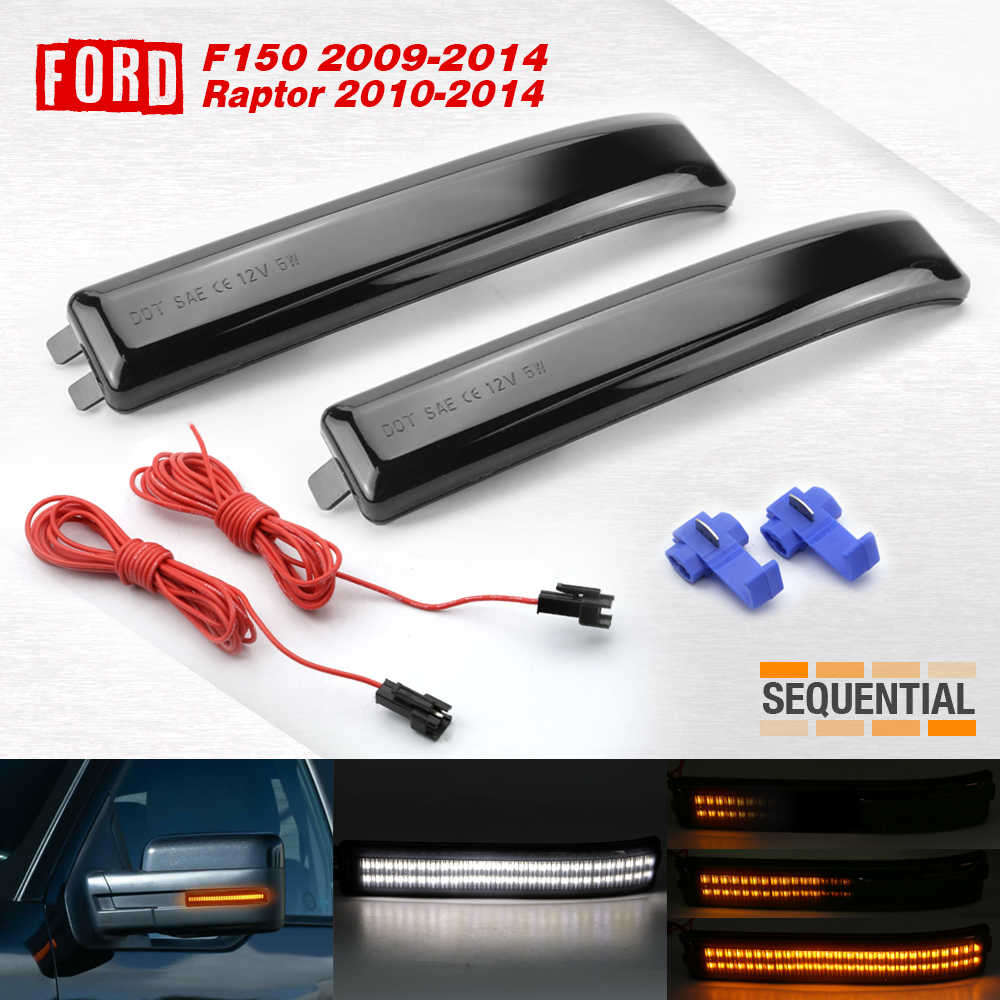 A pair of smoked marker light assemblies for a Ford F150 2009-2014 Raptor, shown with red wiring harnesses, blue connector clips, and a bottom strip showing illuminated amber and white light functions. The brand 'Sequential' is visible on the right.