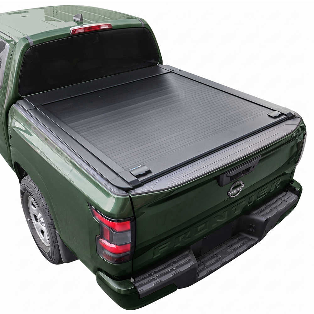 A black roll-up truck bed cover installed on the bed of a dark green pickup truck, shown from a rear three-quarter angle against a plain white background.