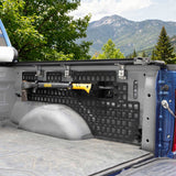 Truck bed with bed side molle panel system and Dewalt tool, mountainous landscape in the background