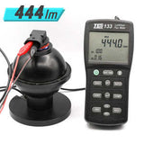 Flux meter with digital display and blue light bulb, showing 444lm.