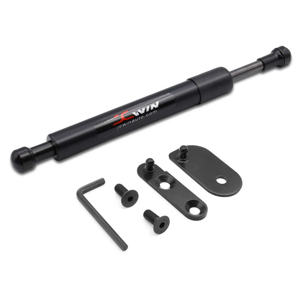 A black hydraulic door stopper extension kit with a gas strut rod, two mounting brackets, two mounting bolts, and an Allen wrench, displayed on a clean white background. The strut features a red and white 'JCWIN' logo.