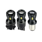 Three black automotive light bulbs on a white background