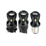 Three black automotive light bulbs on a white background