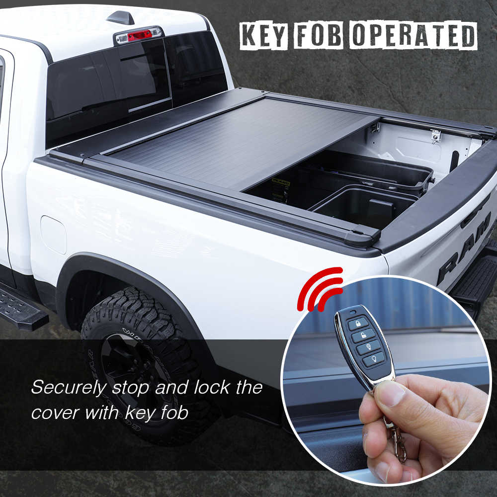 Truck bed cover with key fob operation feature, showing a hand holding a key fob.