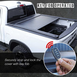 Truck bed cover with key fob operation feature, showing a hand holding a key fob.