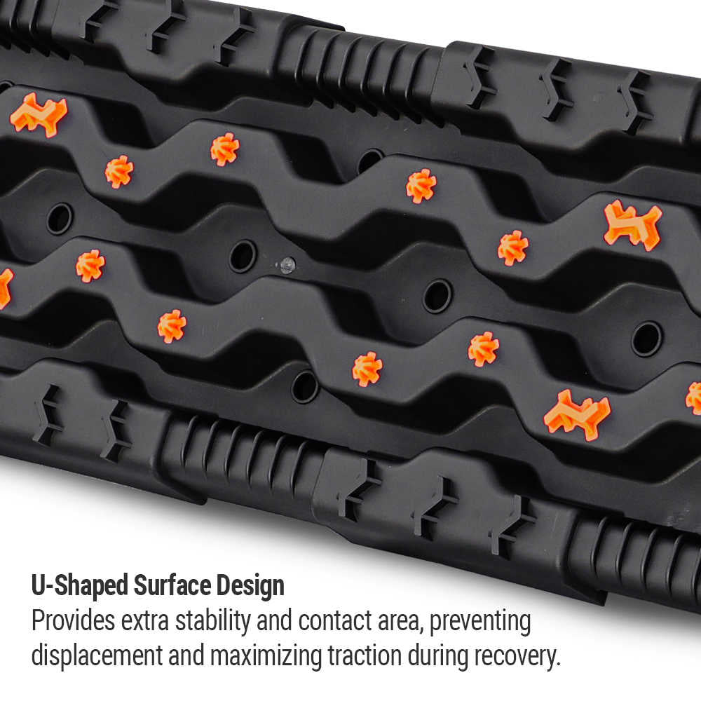 Black U-shaped traction mat with orange spikes for truck recovery, maximizing grip and stability