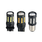 Three black LED car light bulbs with yellow and white illuminated chips, shown on a plain white background. One bulb on the right has a silver metal base.