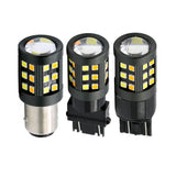 Three LED light bulbs with different base types on a white background