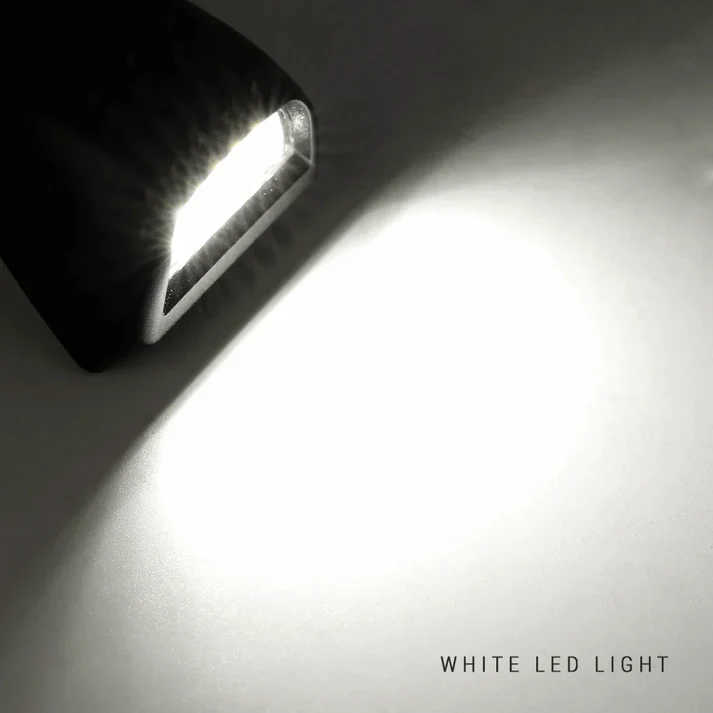 A close-up of a black LED light fixture casting a bright white beam of light onto a dark surface, with the text 'WHITE LED LIGHT' in the bottom right corner.