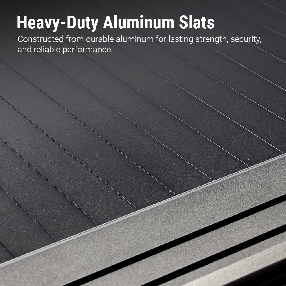 Close-up of dark gray to black aluminum slats with a metallic frame edge, overlaid with the text 'Heavy-Duty Aluminum Slats' and a descriptive feature callout.