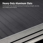 Close-up of dark gray to black aluminum slats with a metallic frame edge, overlaid with the text 'Heavy-Duty Aluminum Slats' and a descriptive feature callout.