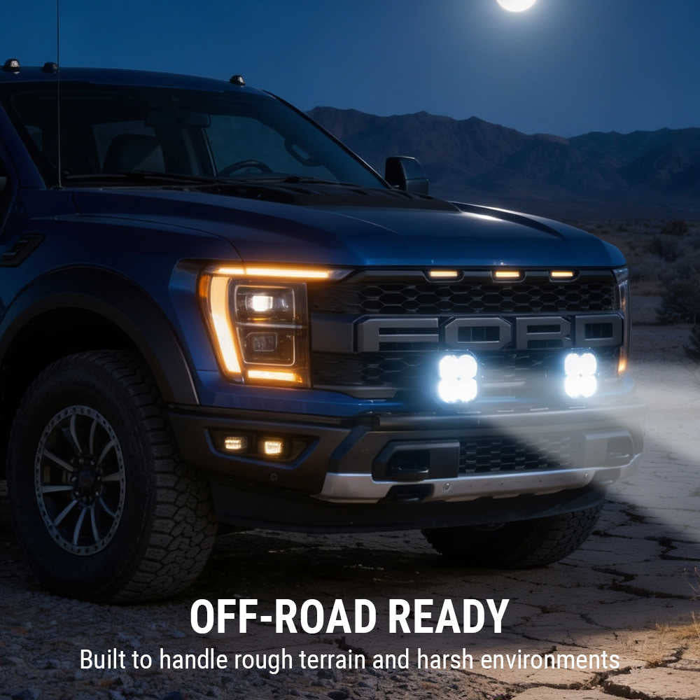 Ford truck with illuminated headlights in a desert landscape at night