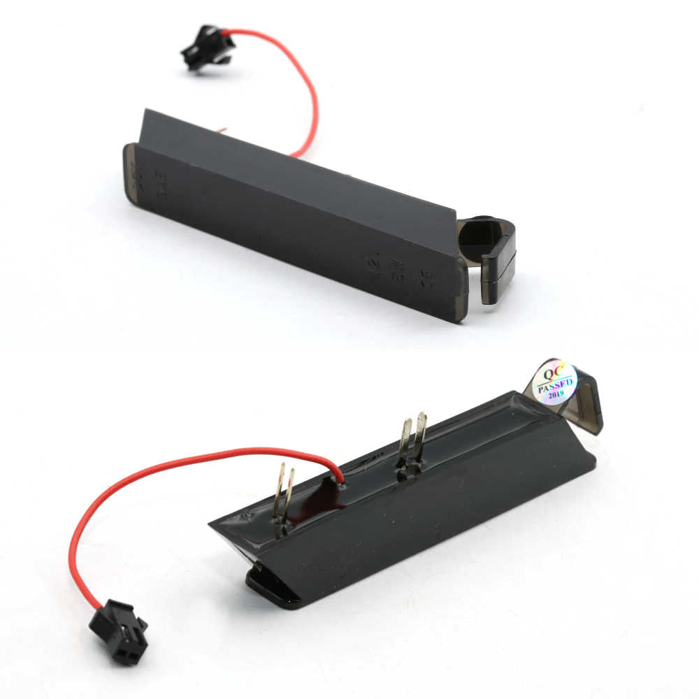 Two black plastic laser pointer alignment caps with red wires and connectors, shown on a white background.
