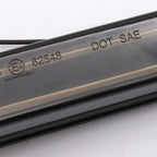 Close-up of a transparent automotive windshield washer fluid reservoir tube with embossed DOT SAE certification markings and a production code 62548.