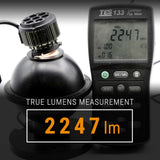 Luminous flux meter measuring 2247 lm next to a light bulb