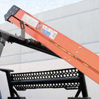 Orange and black mechanical device with a white label against a light gray background
