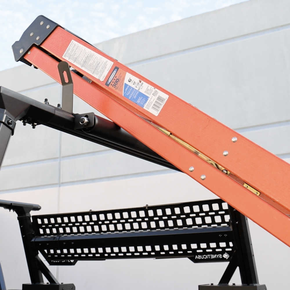Orange and black mechanical device with a white label against a light gray background