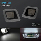 A set of four car interior LED license plate lights for Ram 1500 (2002-2010 models). The image shows the four square-shaped light units in the dark, along with a demonstration of the bright white LED light output and a license plate illuminated in a real car interior setting.