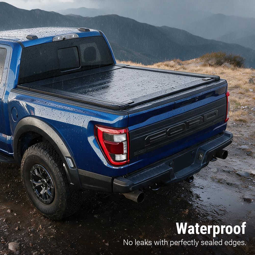 A blue Ford pickup truck parked outdoors on a rocky mountain road, shown from the rear three-quarter angle with a black tonneau cover over the bed. Text in the lower right reads 'Waterproof' and 'No leaks with perfectly sealed edges.