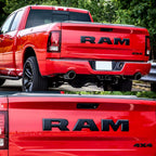 Red Ram 1500 truck rear view with 4x4 badge and dual exhaust, showcasing tailgate emblem and rugged design