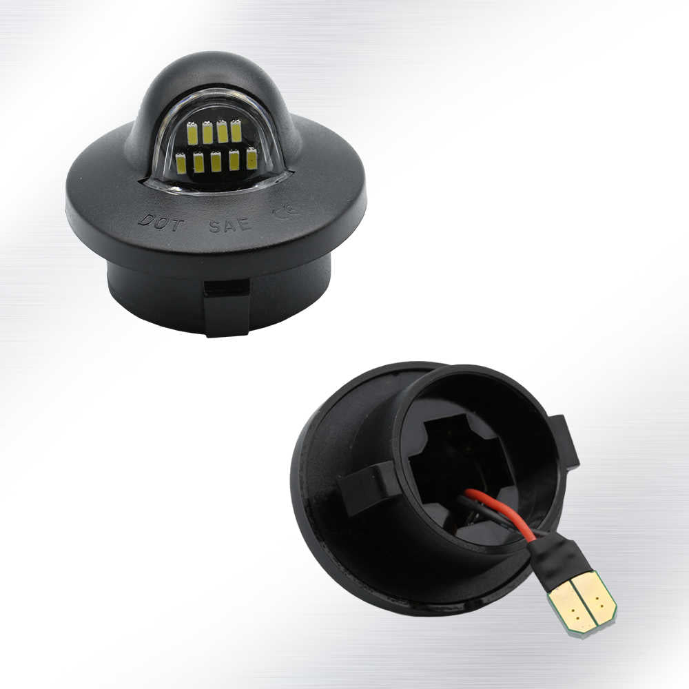 A pair of black automotive LED marker lights shown on a light gray gradient background, with one light displaying the dome-shaped LED lens and the other showing the open back with internal wiring and a connector plug.