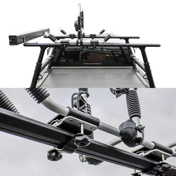 Top-down view of a black roof rack system mounted over a vehicle bed, with a close-up detail shot of the mounting hardware and springs below on a white background.