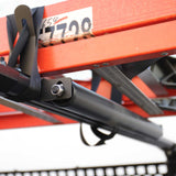 Close-up of a red agricultural implement on a blurred background