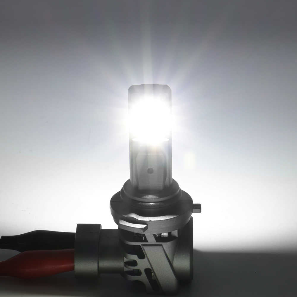 Car headlight bulb with bright light on a gray background
