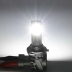 Car headlight bulb with bright light on a gray background