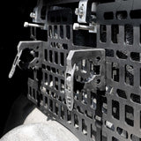 Close-up of a metal molle panel with bolts on a dark background