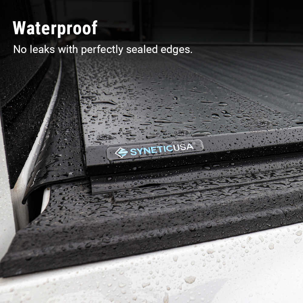 SYNETICUSA waterproof mat with water droplets on a vehicle floor.