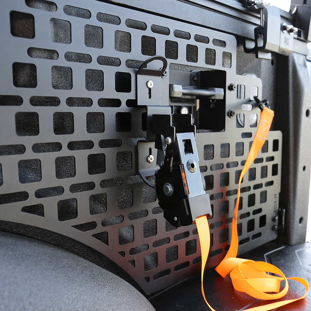 Close-up of a vehicle's cargo area with a black lattice design and an orange strap.