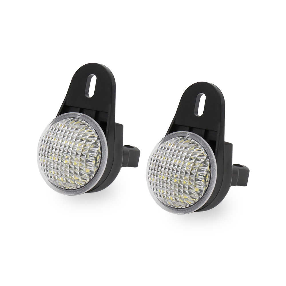 Two black circular LED light reflectors with silver trim and a textured clear lens, shown side by side on a white background.