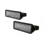 A pair of black rectangular LED license plate lights with clear ribbed lenses, shown on a plain white background.
