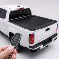 White Chevy Colorado truck with retractable bed cover and remote.