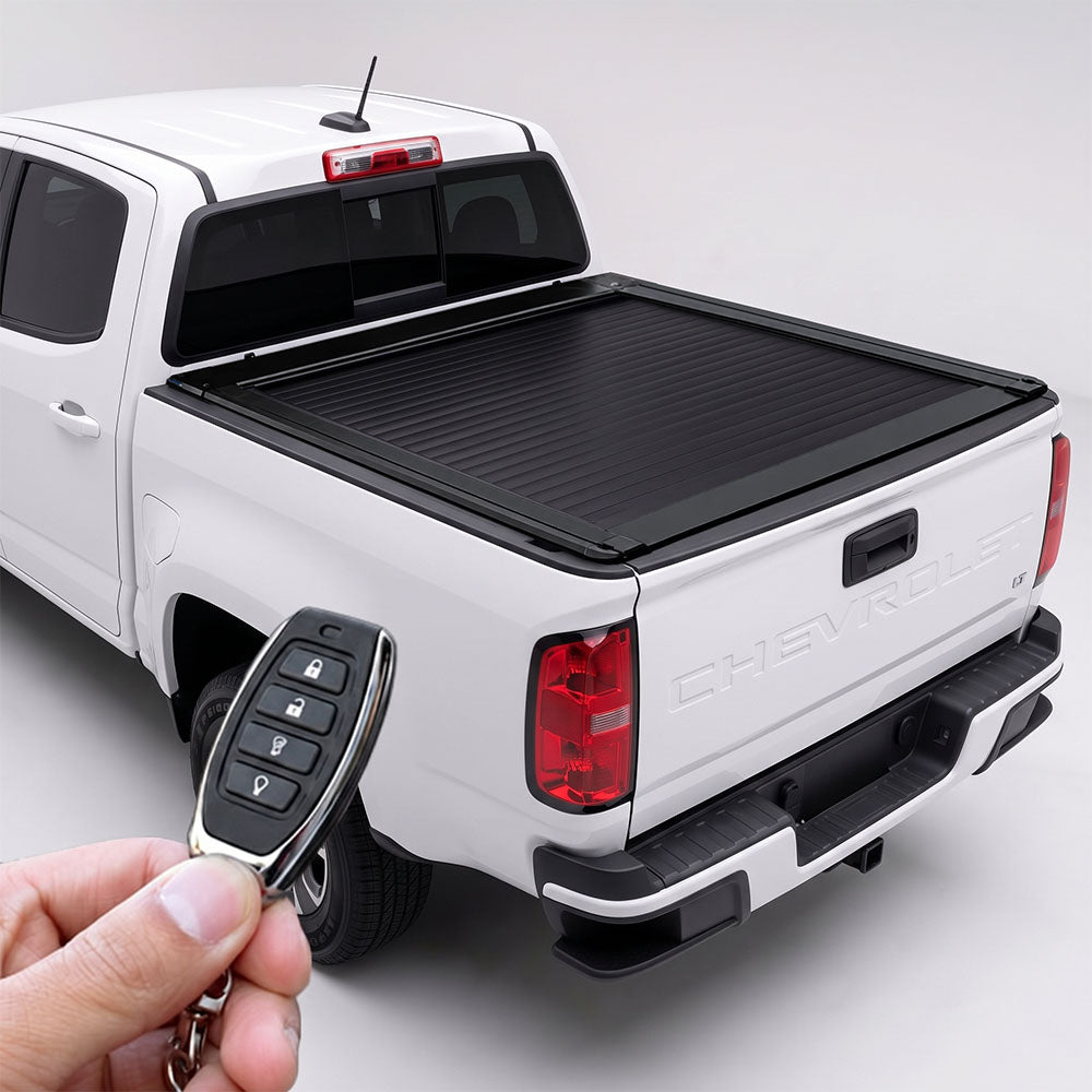 White Chevy Colorado truck with retractable bed cover and remote.