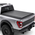 Silver truck with a soft roll up tonneau cover on a white background.