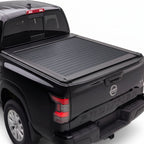 A black Nissan Frontier pickup truck with a black retractable tonneau cover