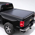 A black Chevrolet Silverado pickup truck with a black retractable tonneau cover