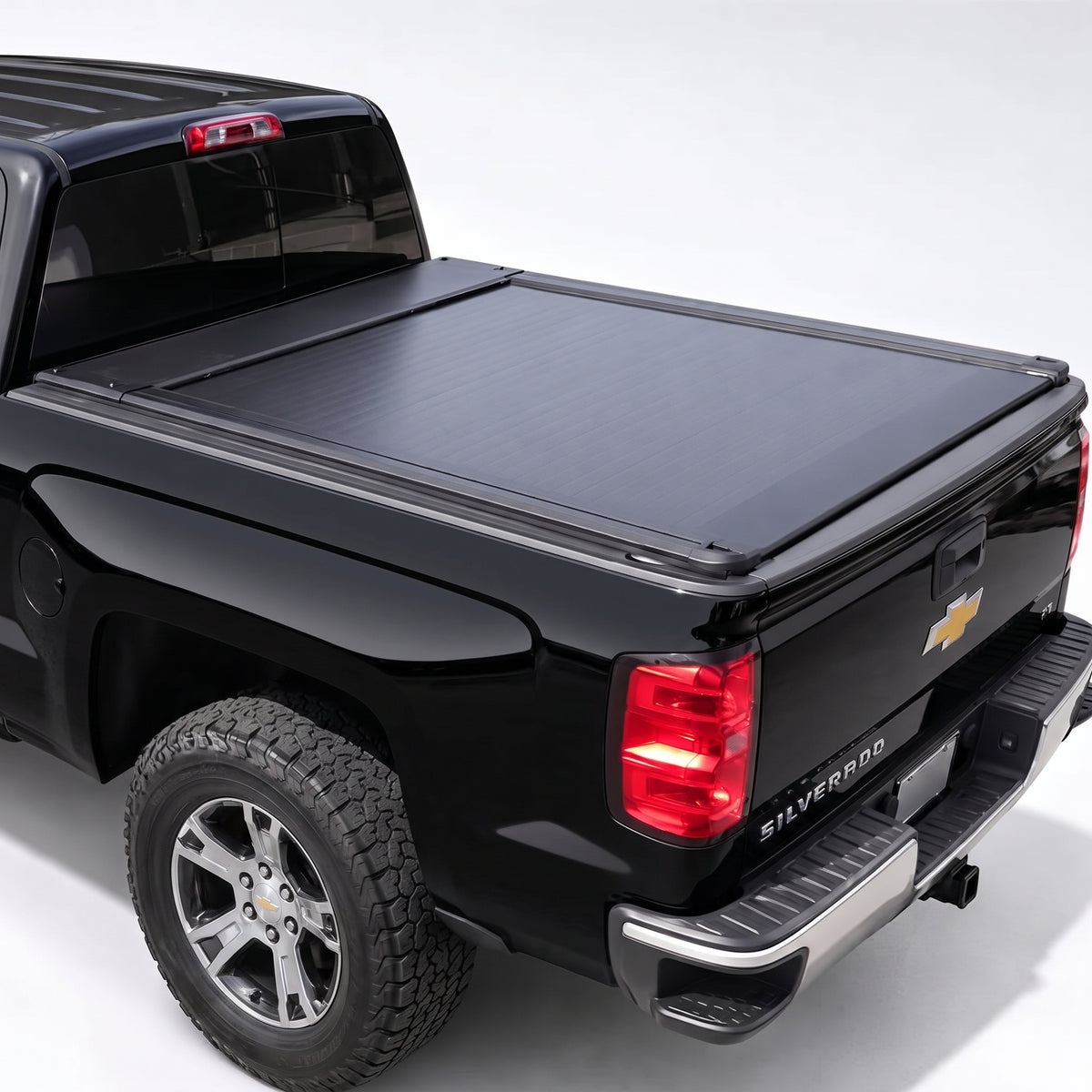 A black Chevrolet Silverado pickup truck with a black retractable tonneau cover
