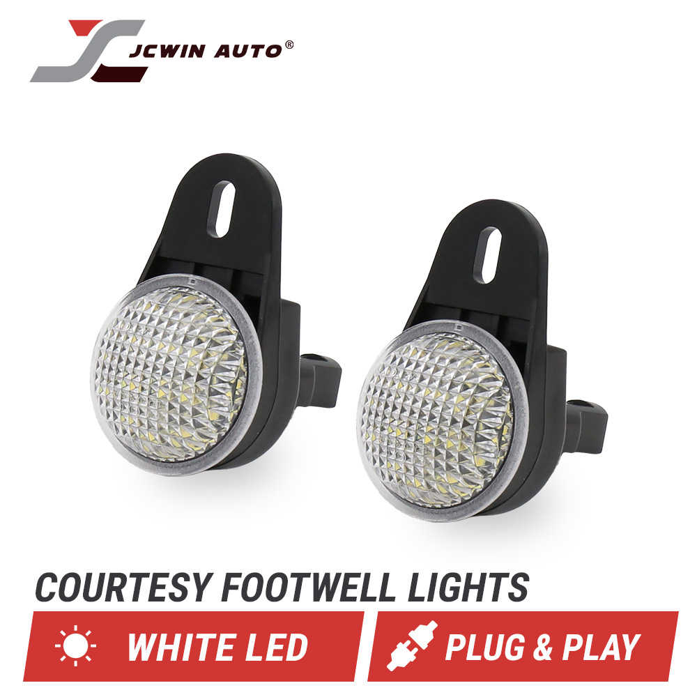 Two black footwell LED lights with clear textured lenses, shown on a white background with the JCWIN AUTO logo and text reading 'COURTESY FOOTWELL LIGHTS', 'WHITE LED', and 'PLUG & PLAY'.