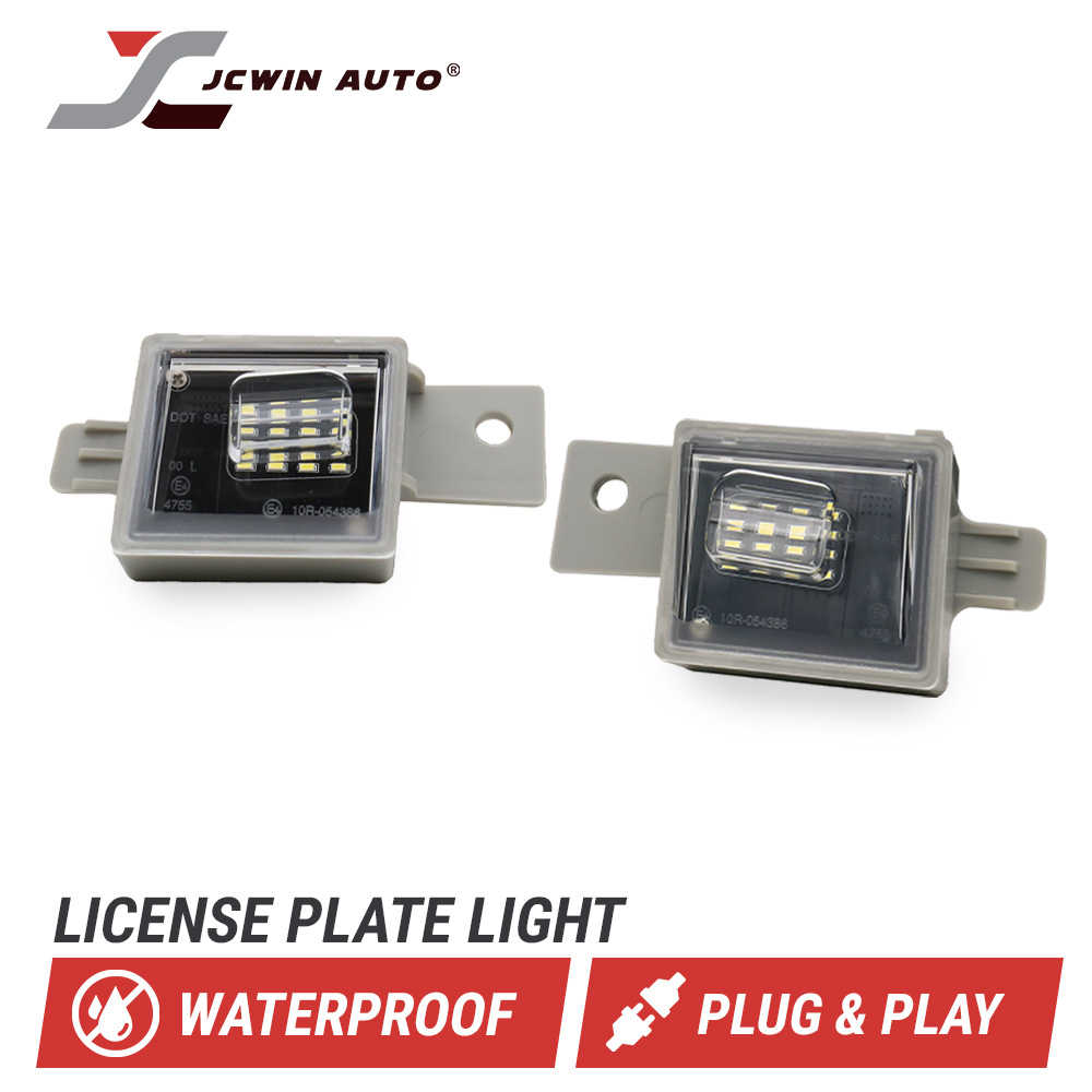 Two license plate light modules with gray metal mounting brackets and clear protective covers, shown on a white background with the JCWIN AUTO logo and text reading 'LICENSE PLATE LIGHT,' 'WATERPROOF,' and 'PLUG & PLAY.'.