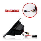 Black plastic automotive electronic component with attached red and black wires and connector, shown on a white background with a circular inset close-up labeled 'CONNECT PLUG'.